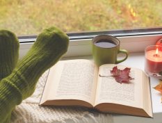 Cozy reading with a fall leaf and coffee
