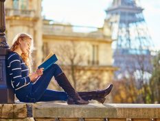 Woman reading by the Eiffel Tower