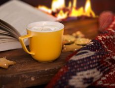 Reading by the fire with hot chocolate