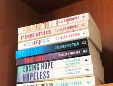 Colleen Hoover books stacked on a shelf