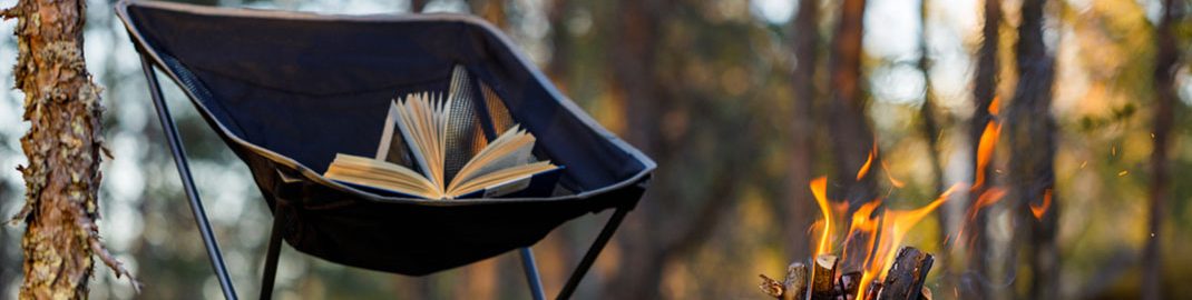 Books in the forest by a campfire