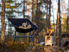 Books in the forest by a campfire